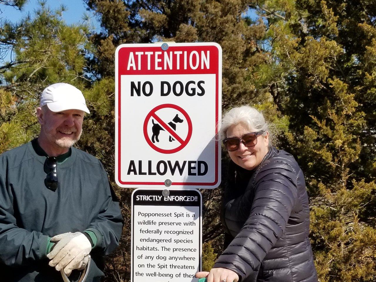 Mike Oleksak and Dawn Peterson installing No Dog Allowed signs on the Spit, at the more popular boat anchoring spots and on Audubon land.